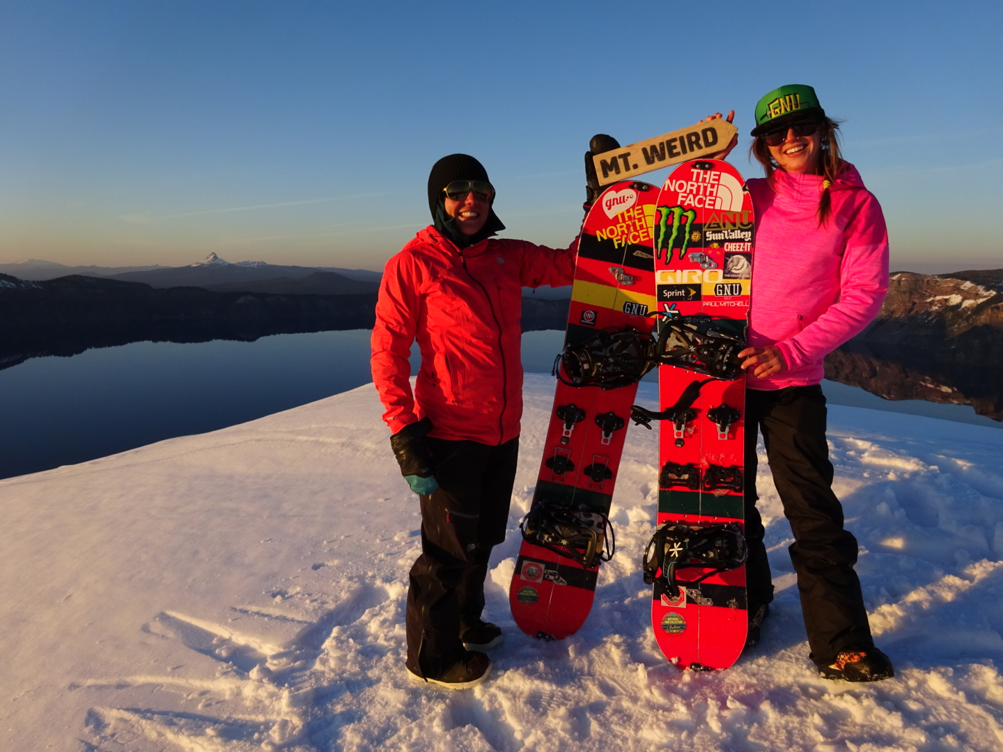 Professional women's snowboarders atop a mountain witht he GNU x pendleton boards