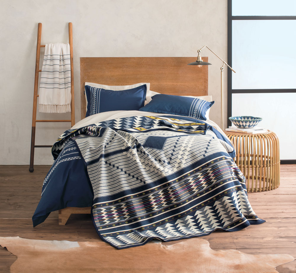 A bed made up with the Pendleton Spirit Seeker blanket.