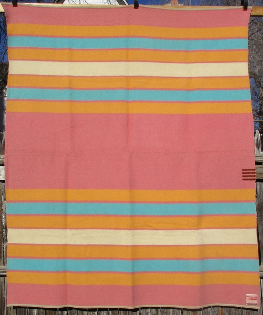 A rose-colored Grand Canyon blanket with four points.