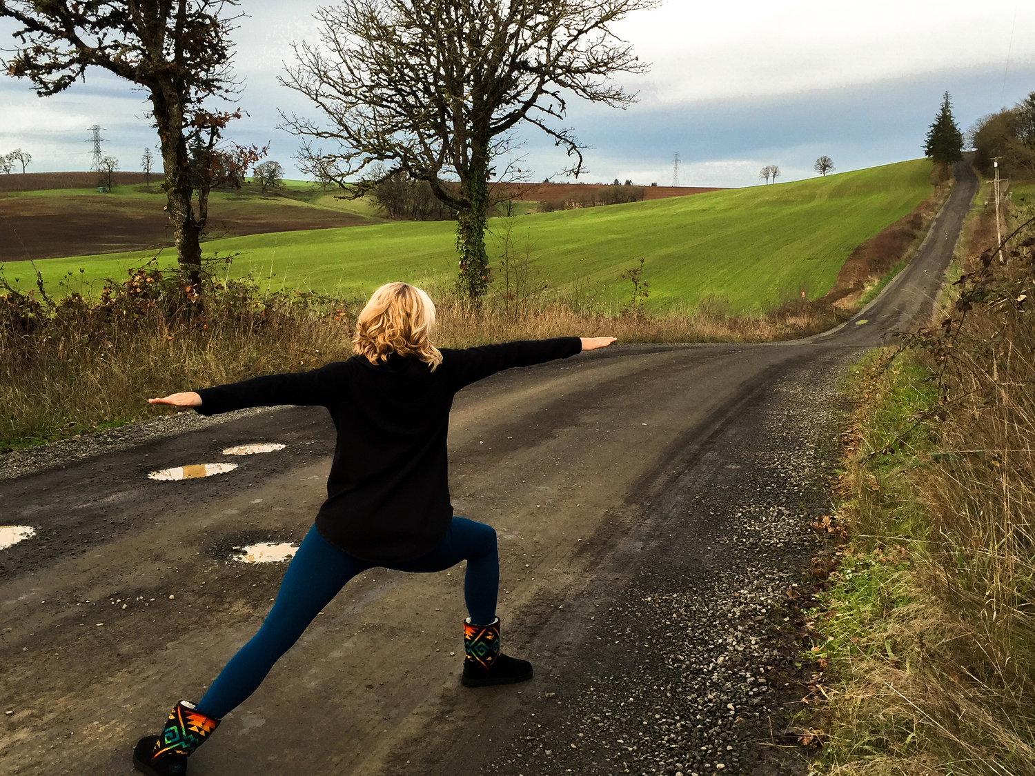 Amy Patterson doing a yoga pose on an Oregon road