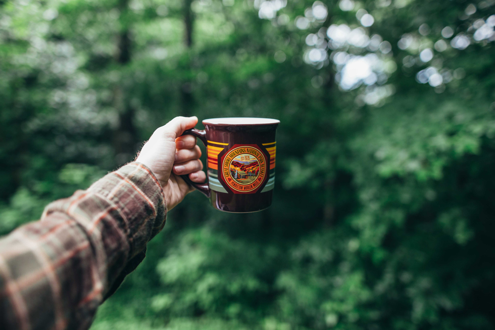 Matthews_ A hand holding out a Great Smoky coffee cup