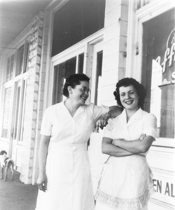 Wearing their waitress uniforms, Louise [left] and her daughter Wilma [right] in front of Louise’s café.