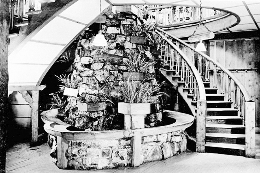 Fountain and spiral stair at Lake Level of Many Glacier Hotel. Courtesy Glacier National Park