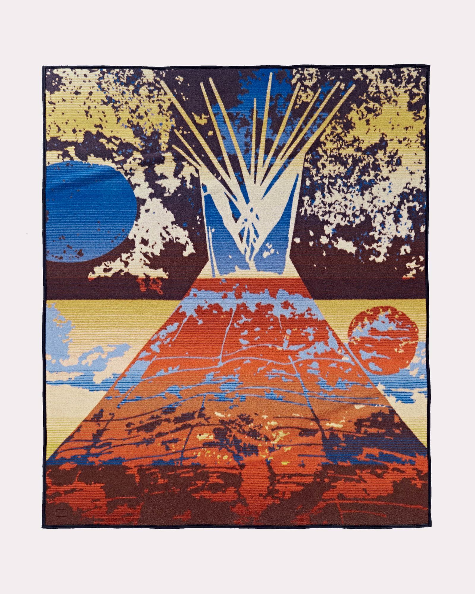 The reverse side of the Pendleton Legendary Series blanket, Full Moon Lodge, which shows a tipi under a full moon, in shades of blue, yellow and orange.