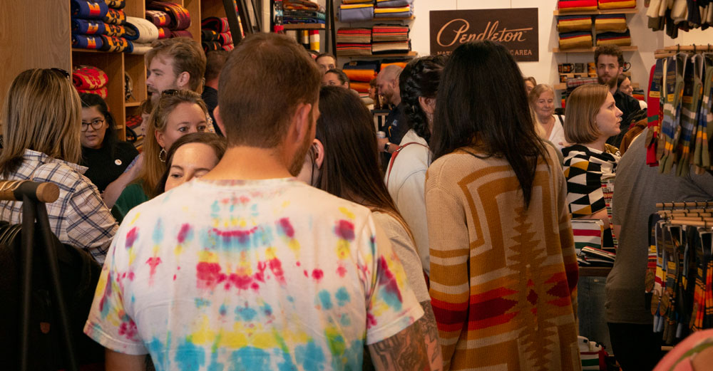 crowd of people inside Pendleton store at party