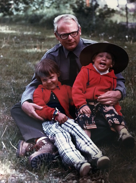 A photo of a father and two children from the 1970s.