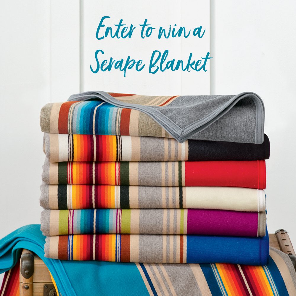 A stack of colorful serape blankets, with the words "Enter to win a serape blanket"