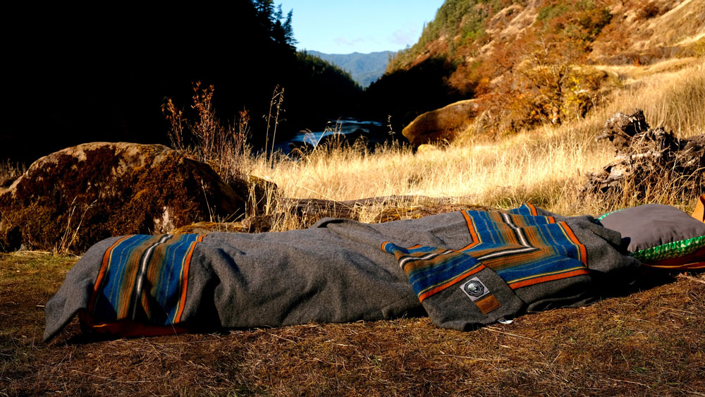 The Olympic National park blanket by Pendleton on a Therm-a-Rest Cot, made up on a patch of dry ground in Oregon.