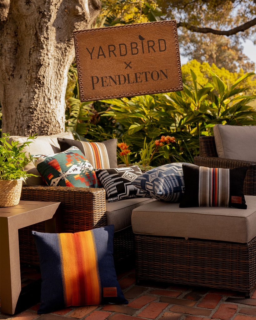 Pillows by Yardbird in Pendleton patterns on an outdoor chaise.