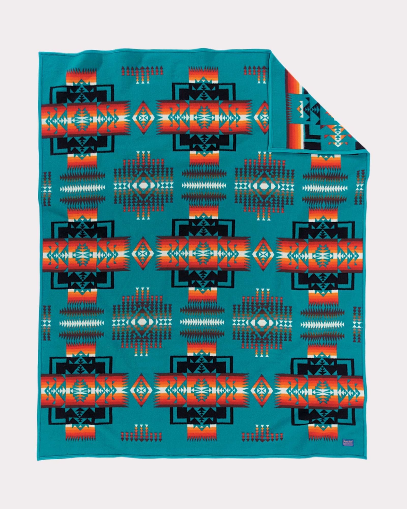 A Pendleton Chief Joseph blanket in turquoise, orange, black and white.