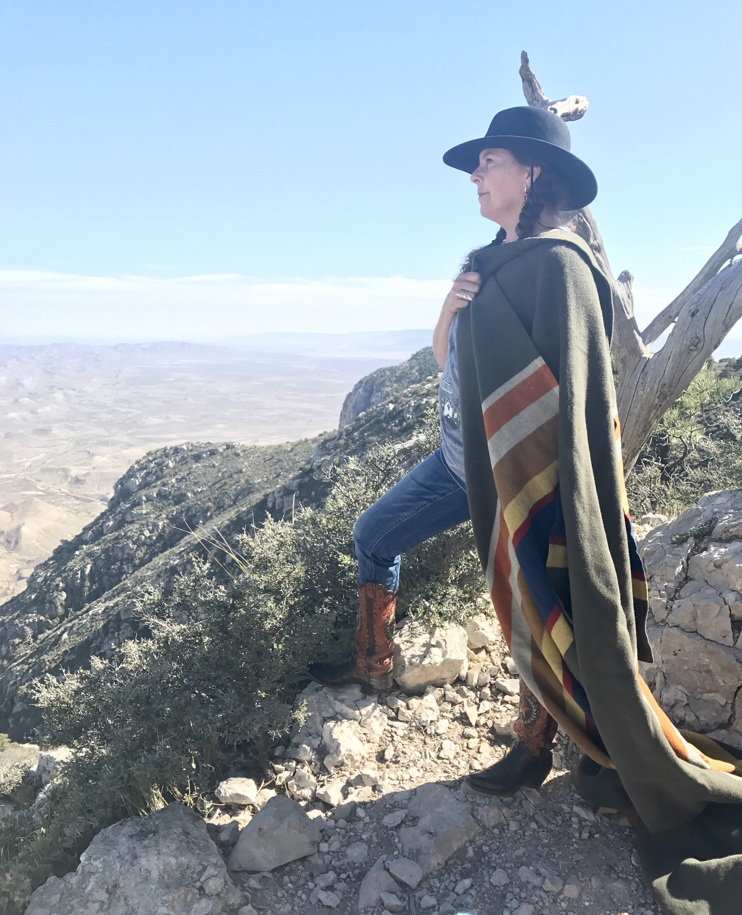 Karla Morton poses on a mountain in the Badlands with her Badlands National park blanket. 