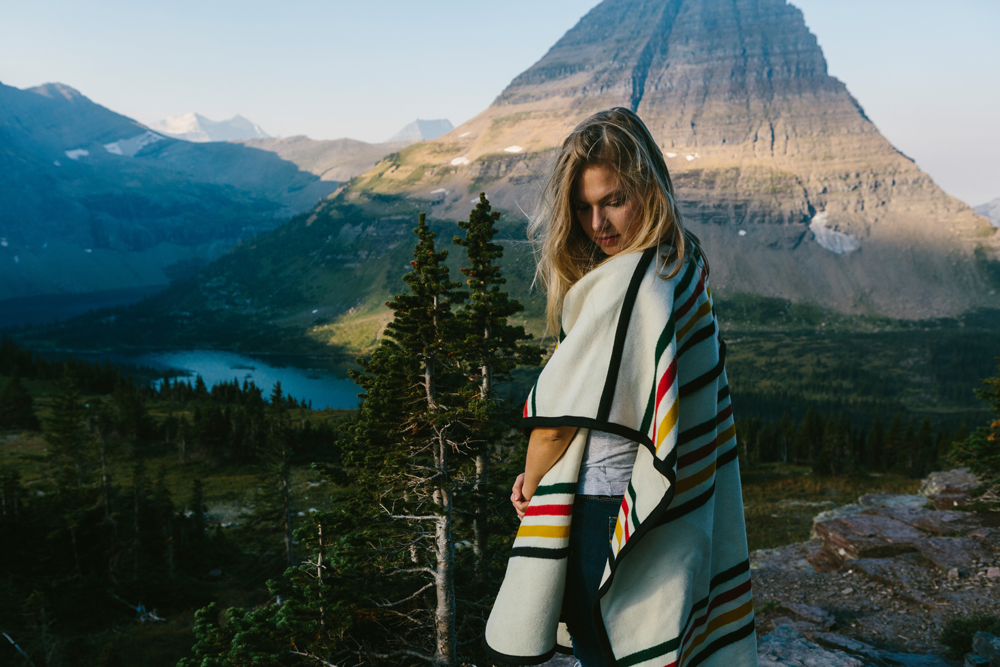 Irey_A woman in a striped cape in front of a glacier