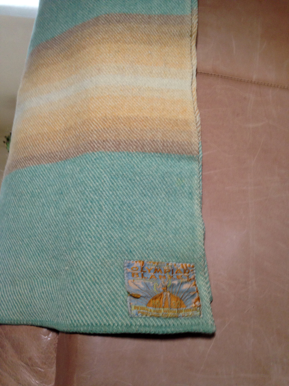 A beautiful Pendleton Olympiad blanket in teal, with a twill weave and an embroidered label. 