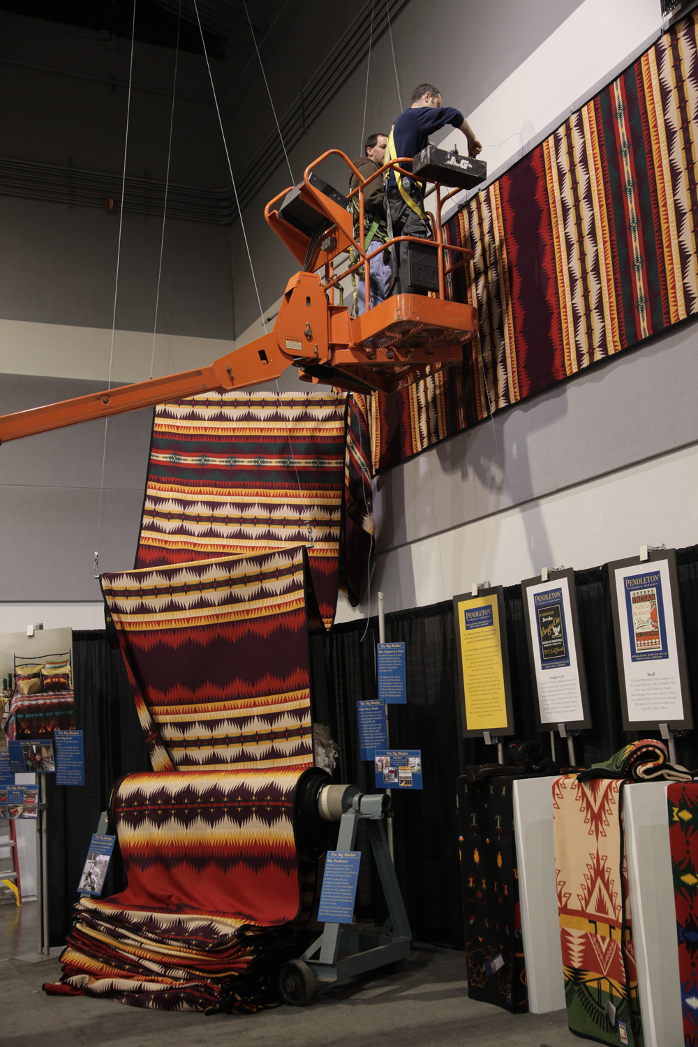 Workers attach the world's longest wool blanket to a wall