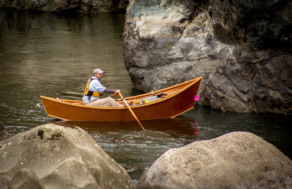 Greg hatten steers his wooden drift boat through a gentler part of the Rogue River.