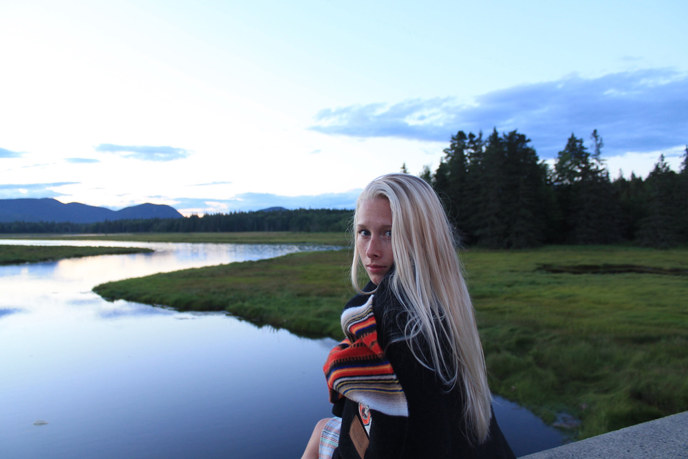 Karlov- A beautiful shot of a woman wrapped in a blanket, standing in Acadia National Park. 