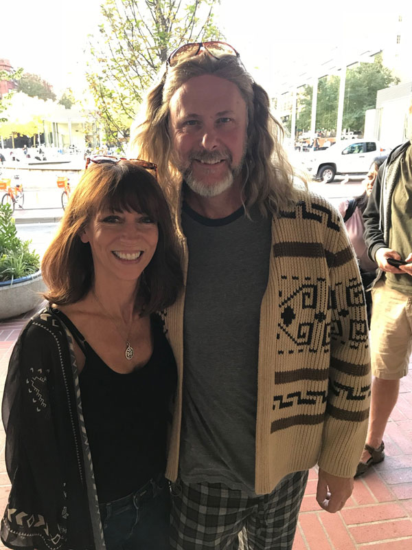 A man dressed as Jeff Lebowski and a woman outside the Prtland Pendleton store, waiting to go into DudeCon.