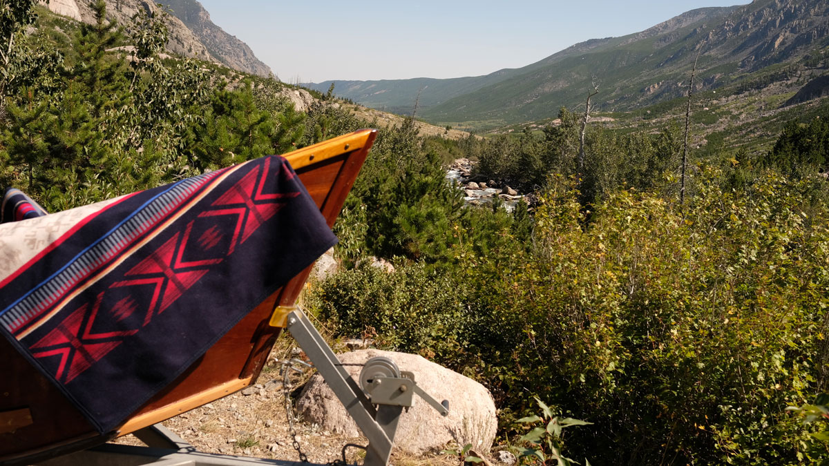 The Pendleton Bighorn blanket rests on the prow of a wooden boat, overlooking the Bighorn canyon. Photo by Greg Hatten.