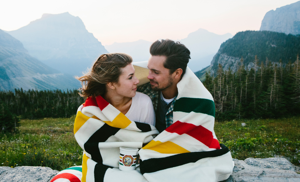 Kristian_Irey photo of a couple wrapped in a Glacier national park blanket in Glacier National Park.