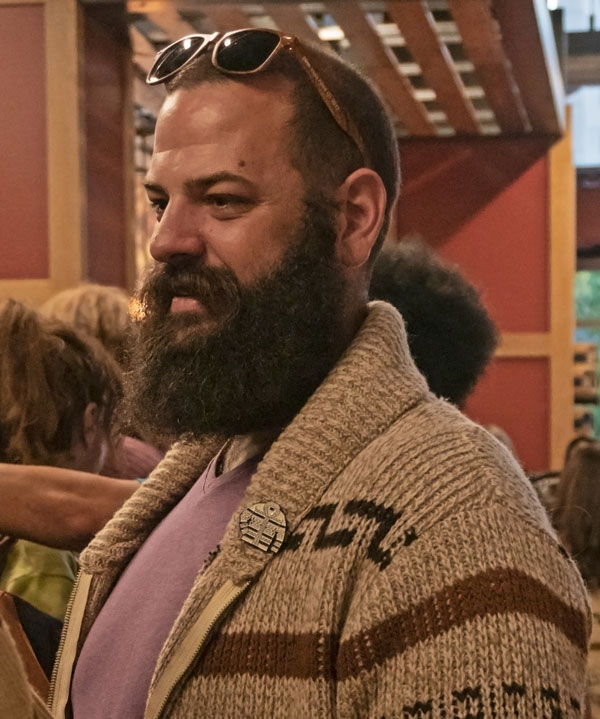 A bearded man wears a vintage Westerley cardigan.