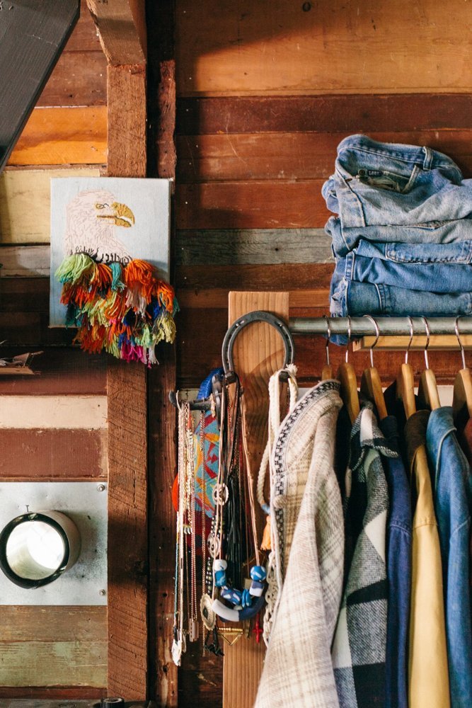 A clothing rack and piece of artwork.