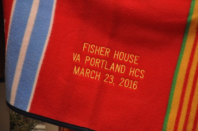 A close shot of the embroidery on the Pendleton Grateful Nation blanket which reads "FISHER HOUSE/VA PORTLAND HCS/MARCH 23, 2016"