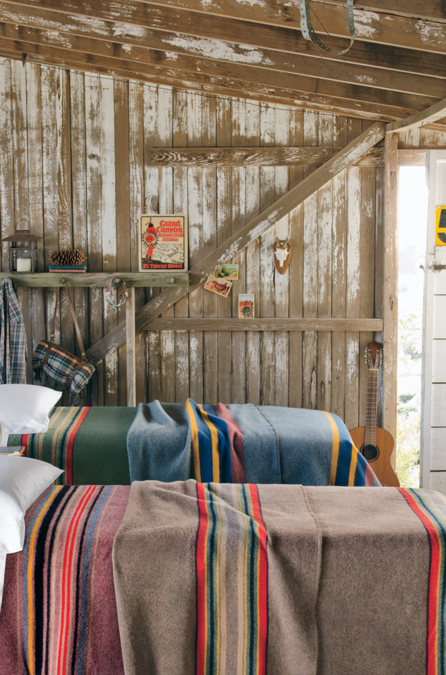 Camp_blankets on beds in a rustic room. 